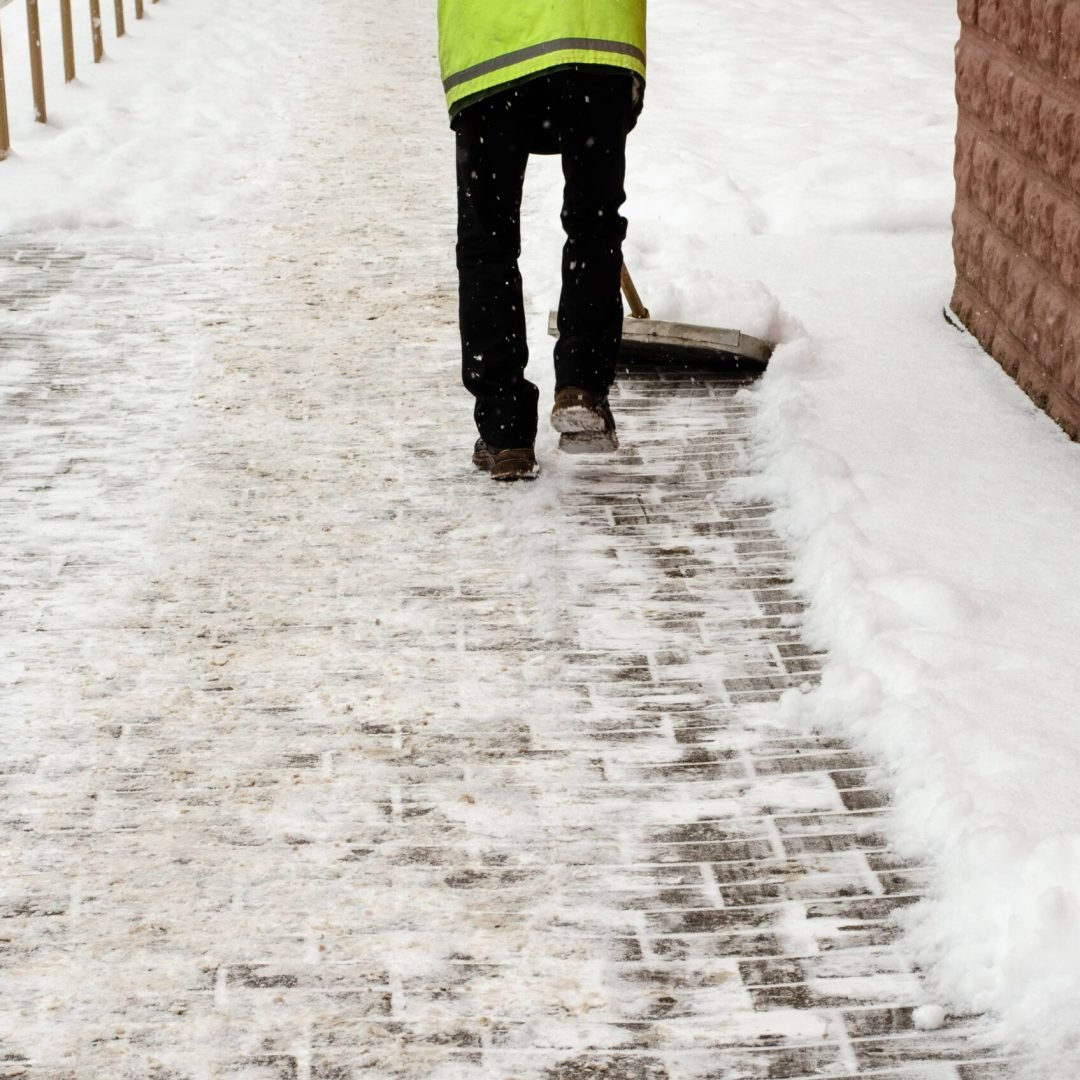 snow-storm-city-roads-sidewalks-covered-with-snow-worker-shovel-clears-snow-bad-winter-weather-street-cleaning-after-snowstorm (1)